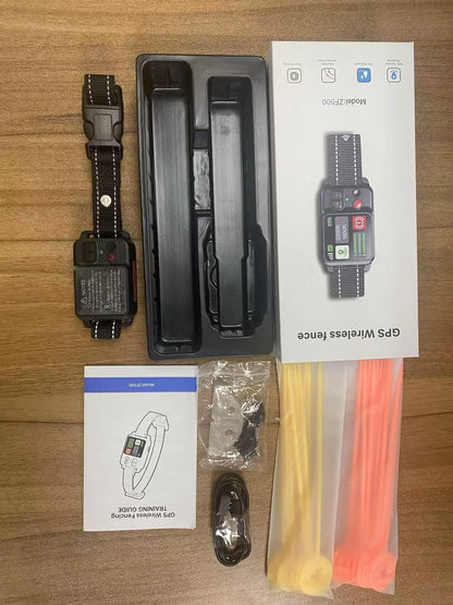 GPS wireless fence system components including collar, packaging, and accessories on a wooden surface.